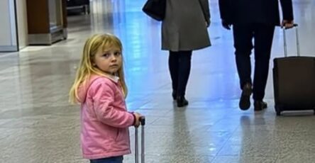 A father embracing his eight-year-old daughter after finding her alone at the airport